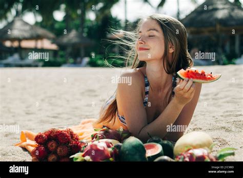 Caucasian Woman Eating Watermelon On Beach Stock Photo Alamy