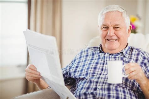 Senior Man Reading Newspaper In Living Room Stock Image Image Of