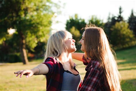 Two Girls Friends Laughing And Hugging Hug And Smile Stock Image