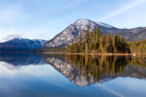 The Cascade Mountains Reflecting In Lake Wenatchee Washington Stock