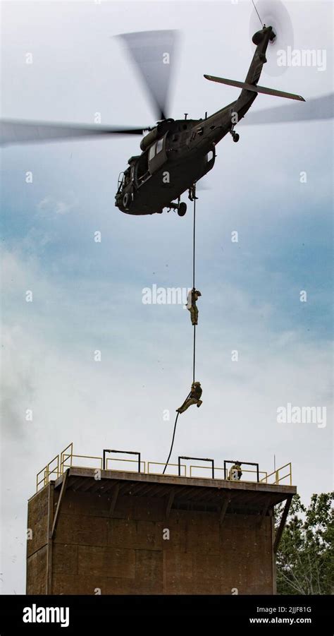 Us Army Special Forces Soldiers Conduct Fast Rope Insertion Training Aboard A Black Hawk Uh