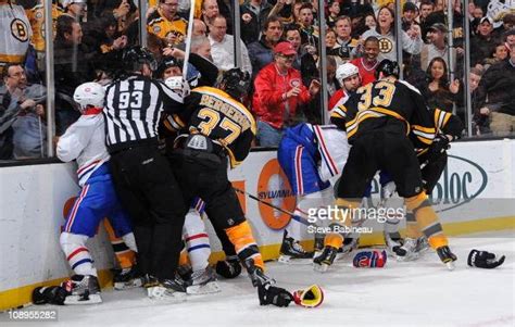 Players Of The Boston Bruins Fight Against Players Of The Montreal