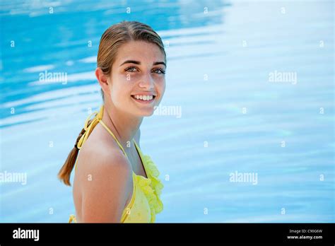 Young Woman In Yellow Bikini By Swimming Pool Portrait Stock Photo Alamy