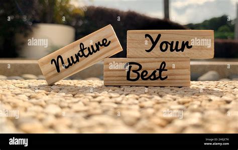 Text On Wooden Blocks Nurture Your Best With Blurred Park Background