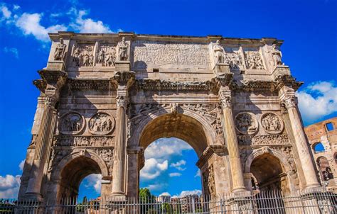 The Arch Of Triumph In Rome Italy Against A Blue Sky With Clouds And