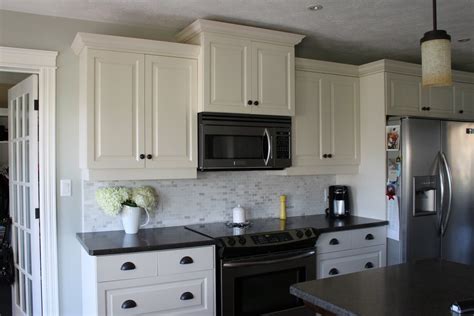 The steel grey caught my eye while i was looking at some of the black granites. White cabinets with gray backsplash | Kitchen Ideas ...