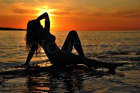 Beautiful Woman Silhouette Posing At Sea Sunset Stock
