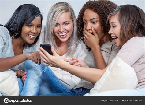 Interracial Group Of Female Friends Laughing At Social Media On Mobile Cell Phone Stock Photo By