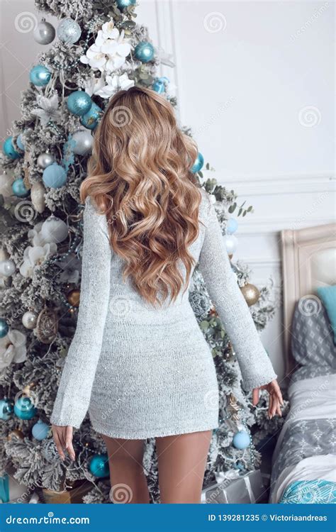 Beautiful Women Celebrating By Christmas Tree Curly Hair Attractive Blonde Girl In Dress With