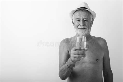 Naked Old Man Lifting Dumbell Against White Background Stock Image