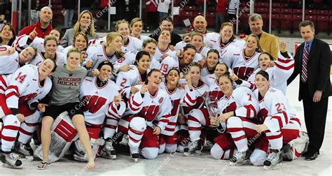 The Wisconsin Womens Hockey Team Poses With The Wcha 1st Place Trophy