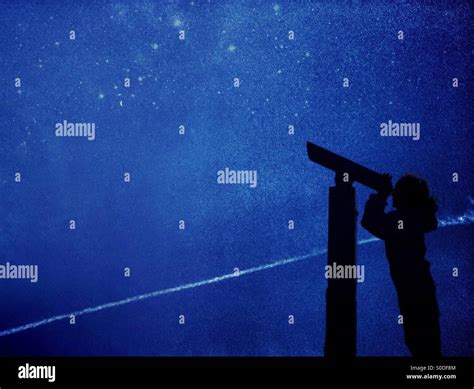 Young Girl In Silhouette Star Gazing Using Telescope Stock Photo Alamy