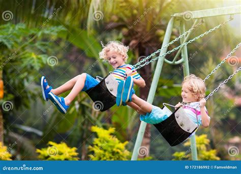 Child On Playground Swing Kids Play Outdoor Stock Photo Image Of