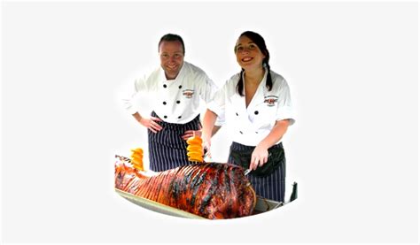 two of our friendly chefs carving a shakespeare spit dolcett female spit roasted 392x400 png