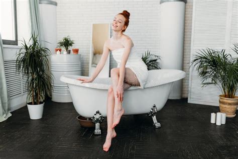 Redhead Woman Preparing Foam Bath In Spacious Bathroom With Green Plants Stock Image Image Of