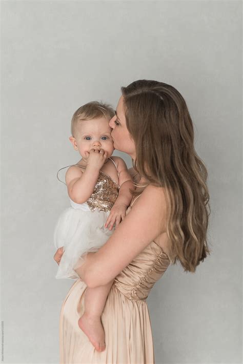 Mother Kissing Her Daughter By Stocksy Contributor Alison Winterroth Stocksy