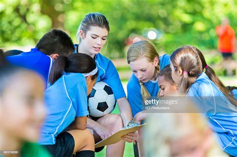 Childrens Soccer Coach Huddled Up With Her Team High Res Stock Photo