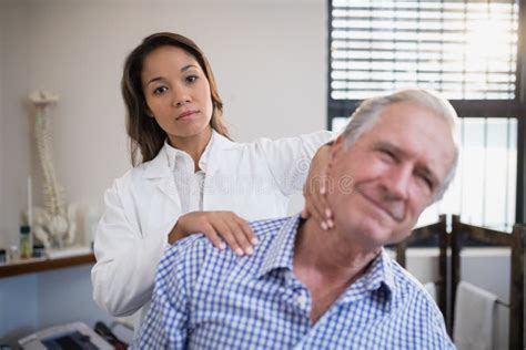 Portrait Of Female Therapist Giving Neck Massage To Senior Male Patient Stock Image Image Of