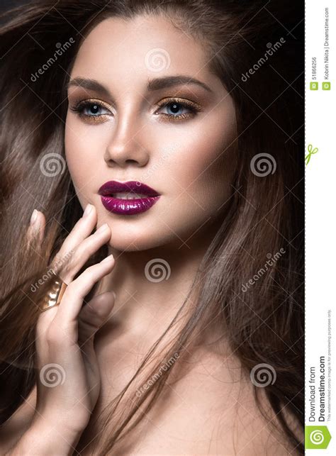 Beautiful Girl With Golden Makeup And Burgundy Lips With