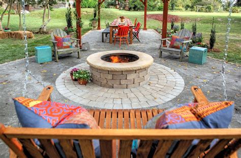 In an aboveground brick fire pit, the bricks function more as a fire ring, containing burning logs. 13 Brick Fire Pits And The Homes And Gardens That Surround ...