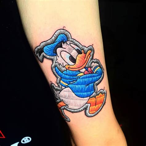 Donald Duck Patch Tattoo Located On The Shin