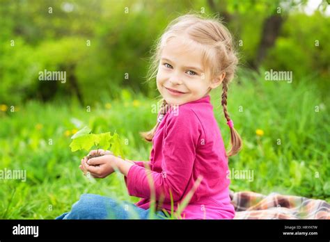 Little Girl Holding Little Green Plant In Her Hands Stock Photo Alamy