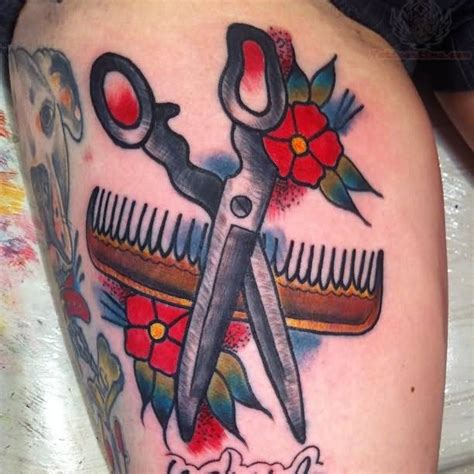 Red Flowers And Scissor With Comb Tattoo On Thigh
