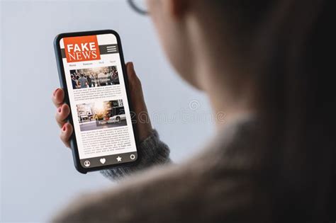 Online Fake News On A Mobile Phone Close Up Of Woman Reading Fake News Hoax Or Articles In A
