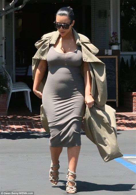 Kim Kardashian Shows Off Her Figure In Dress And Open Trench Coat Daily Mail Online