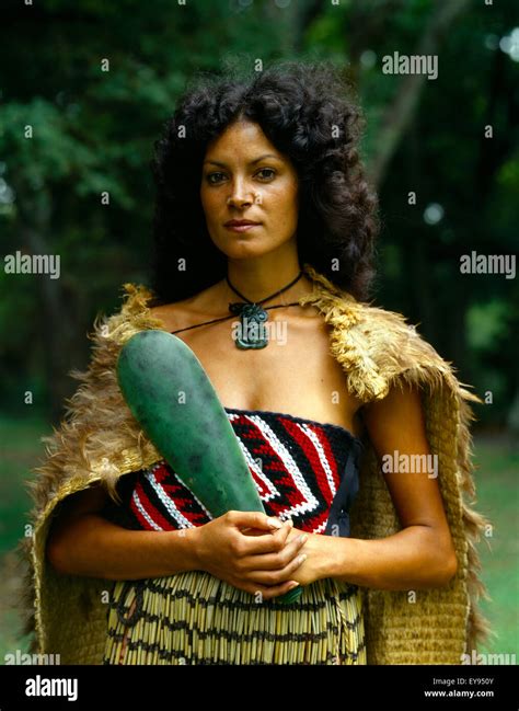 New Zealand Maori Woman In Traditional Dress Wearing Cloak And Piupiu Skirt Holding Pounamu Mere