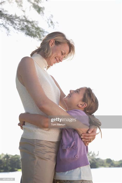 Femme Et Jeune Fille Embrassant À Lextérieur Photo Getty Images