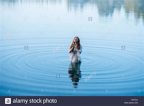 Too phat,ruffedge,kru,shazzy,phlowtron,ella standing in the eyes of the world. Young woman standing in lake ripples praying with eyes ...