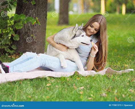 Attractive Young Woman Hugs Funny Siberian Husky Dog And Gives H Stock