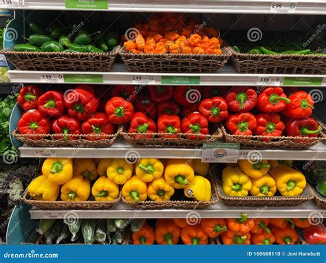 The Fresh Produce Aisle Of A Grocery Store With Colorful Fresh Fruits