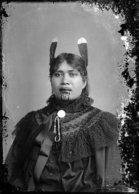 an old black and white photo of a woman with horns on her head wearing a costume