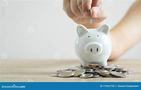 Money Savings Concepts Hand Holding Coin To Put In Piggy Bank To Spend