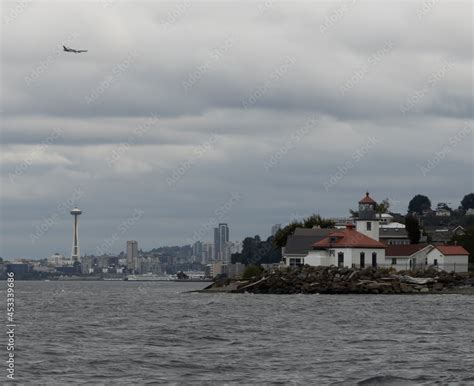 Alki Point Lighthouse As Seen From Puget Sound With The Space Needle In