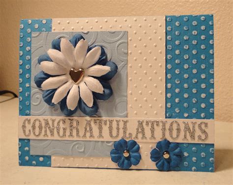 A Blue And White Card With A Flower On The Front Congratulations