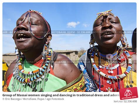 Group Of Massai Women Singing And Dancing In Traditional Dress And