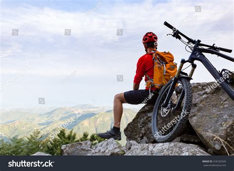Mountain Biker Looking At View On Bike Trail In Autumn Mountains Male