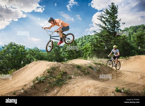 Two Male Friends Riding Bmx And Mountain Bikes On Rural Pump Track