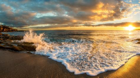 Waves splashing on beach against cloudy sky at sunset, Oak Park