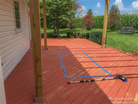 The deck boards made painting stripes a cinch! Painted Outdoor Rug. A DIY Rug Tutorial. | The Heathered Nest