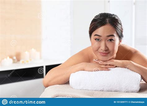 Beautiful Asian Woman Lying On Massage Table In Spa Salon