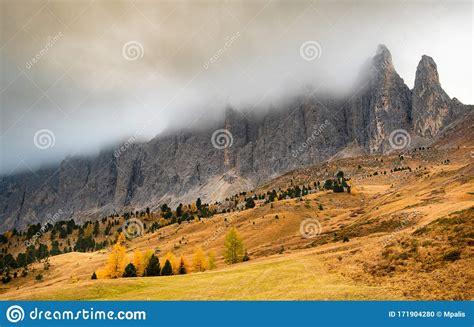 Dolomite Mountain Peaks Covered In Fog During Sunrise Stock Photo