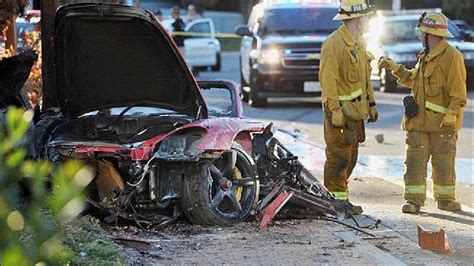 First Responders Gather Evidence Near The Wreckage Of A Porsche Sports