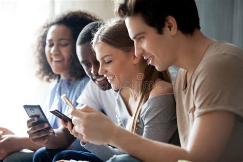 Young People Sitting Together Indoor Using Gadgets Stock Photo Image