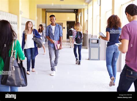 Group Of High School Students Walking Along Hallway Stock Photo Alamy