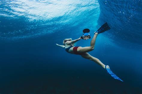 wearing dafins and using an aquatech water housing sarah lee surf trip underwater photography