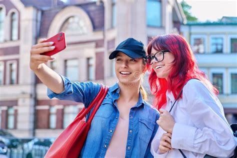 Two Beautiful Teenage Females Having Fun Taking Selfie Portrait On Smartphone Stock Image